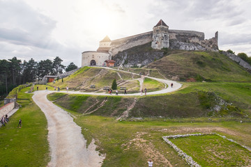 Panoramic view of the inner courtyard of the Rasnov Fortress with walking tourists in the foreground, Rasnov city, Brasov county, Romania