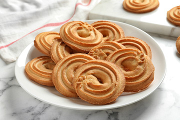 Plate with Danish butter cookies on marble table