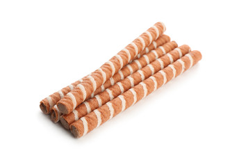 Delicious chocolate wafer rolls on white background. Sweet food