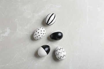 Painted Easter eggs on grey background, flat lay