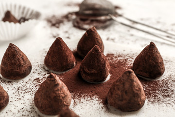 Tasty sweet truffles on white table