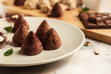 Plate with tasty sweet truffles on table