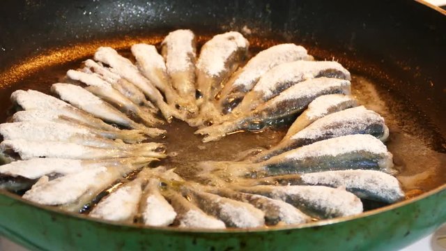 close-up pan fried and baked fish, cook anchovies in a pan,