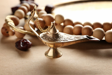 Aladdin lamp of wishes and tasbih on table