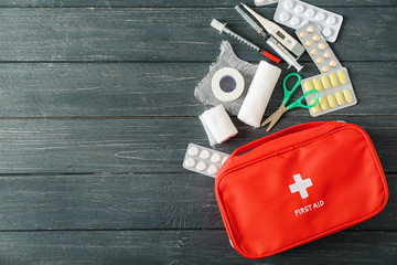 First aid kit on wooden background