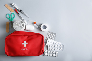First aid kit on light background