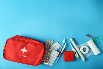 First aid kit on color background