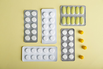 Different pills on color background