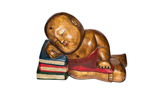 Monk statue on books isolated on white background