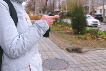 Unrecognizable woman got lost in the city and looking for a route using the Navigator in the mobile...