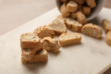Tasty Italian biscotti on light board, closeup