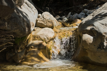 Crystal clear water of a cold mountain creek at rocky terrain of Samaria gorge, south west part of...