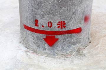 Red handwriting on the cement pole
