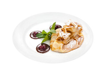 Delicious pancake with cherry and chocolate on plate isolated on White Background. Fresh Homemade Crepes with mint