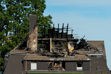 house with roof and top floor destroyed by fire