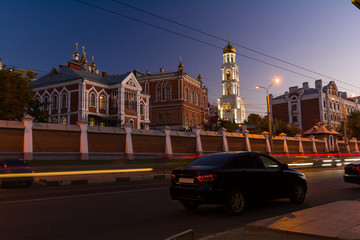 The evening picture of beautifully lit monastery with gold domes against the background of the blue sky and the moon.