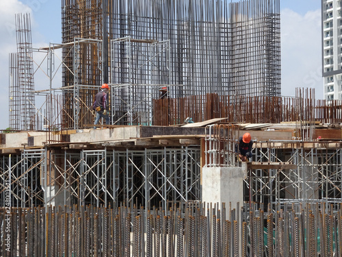 Construction Workers Working At The Construction Site In Malaysia During Daytime They Are Required To Wearing Appropriate Safety Gear To Avoid An Accident Wall Mural Aisyaqilumar