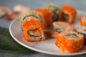 delicious sushi rolls with fresh fish caviar and soy sauce useful