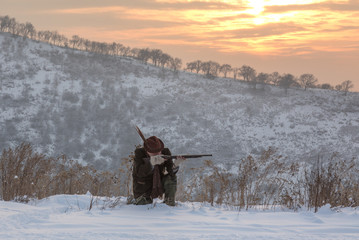 vintage hunter with a gun in winter