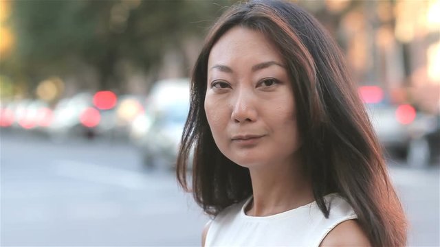 Asian business woman portrait looking confident on the street