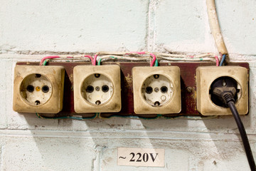 old sockets with plug on the wall