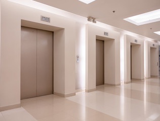 Modern steel elevator cabins in a business lobby or Hotel, Store, interior, office,perspective wide angle. Three elevators in hotel lobby