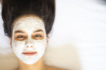 Young woman with facial mask, spa concept