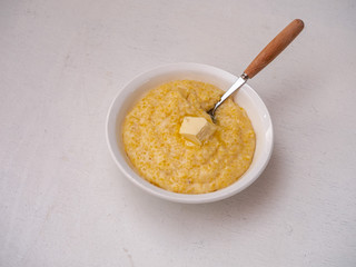 Corn milk porridge in a deep plate with a spoon