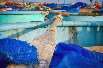 Vietnamese fishing boats on the sandy beach. Paddle close up. Asia, Vietnam, Mui Ne, Phan Thiet.