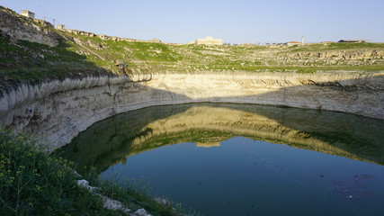Fototapeta na wymiar Obruk sinkhole landscape around Konya Province, Turkey. Panoramic view of karst lake in Asia. Reflection of a crater lake. a cavity ground, especially in limestone bedrock, caused by water erosion.