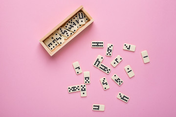 Board game of dominoes on a pink background