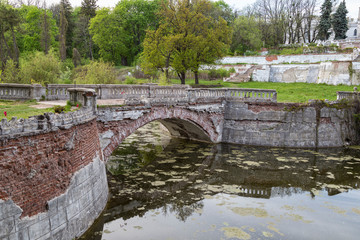 Fototapeta na wymiar Old park with pond and bridge .Sharovka Castle . Ukraine.