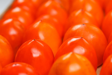 Fresh ripe persimmons in market. Persimmons background.