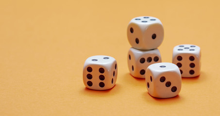 Dice on orange color background, copy space