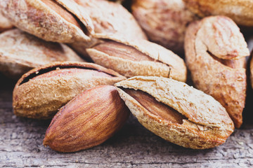 A pile of almonds on white background. Almonds are rich in nutrients, vitamins, and minerals that are essential to the body.
