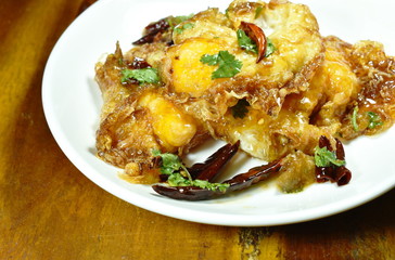 fried egg dressing tamarind spicy and sweet sauce on plate