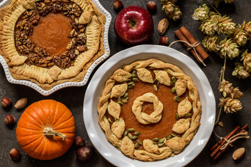 pumpkin pie with nuts, pumpkin seeds and Apple on dark background