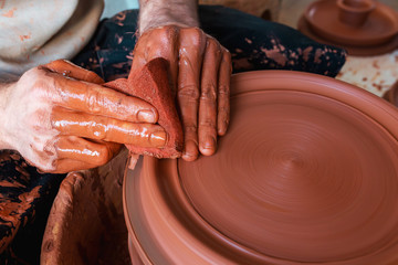hands of potter on potters wheel