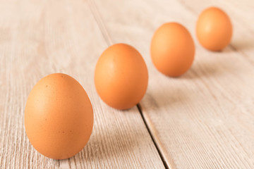 Chicken eggs on a wooden table. Selective focus.