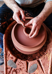 hands of potter creating a jar