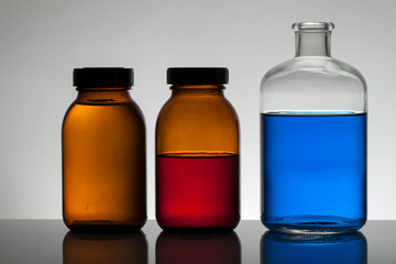 Liquid in laboratory bottles. Scientific biochemical laboratory. Colorful liquid.