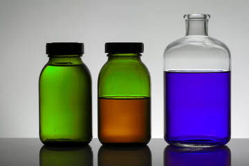 Liquid in laboratory bottles. Scientific biochemical laboratory. Colorful liquid.