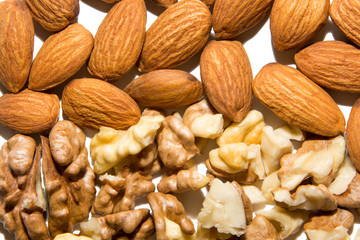 Close-up of walnut and almond. Fruits of walnuts and almonds. On white background. Isolated.