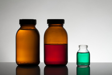Liquid in laboratory bottles. Scientific biochemical laboratory. Colorful liquid.