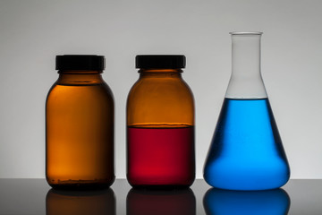 Liquid in laboratory bottles. Scientific biochemical laboratory. Colorful liquid.