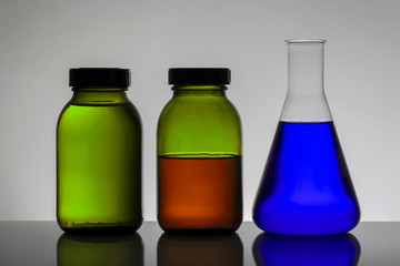 Liquid in laboratory bottles. Scientific biochemical laboratory. Colorful liquid.