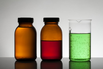 Liquid in laboratory bottles. Scientific biochemical laboratory. Colorful liquid.