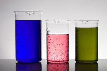Liquid in laboratory bottles. Scientific biochemical laboratory. Colorful liquid.