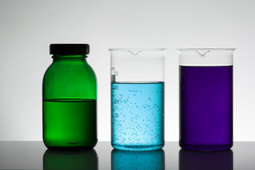 Liquid in laboratory bottles. Scientific biochemical laboratory. Colorful liquid.