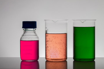Liquid in laboratory bottles. Scientific biochemical laboratory. Colorful liquid.